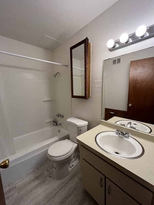 a bathroom with a sink toilet and a bath tub