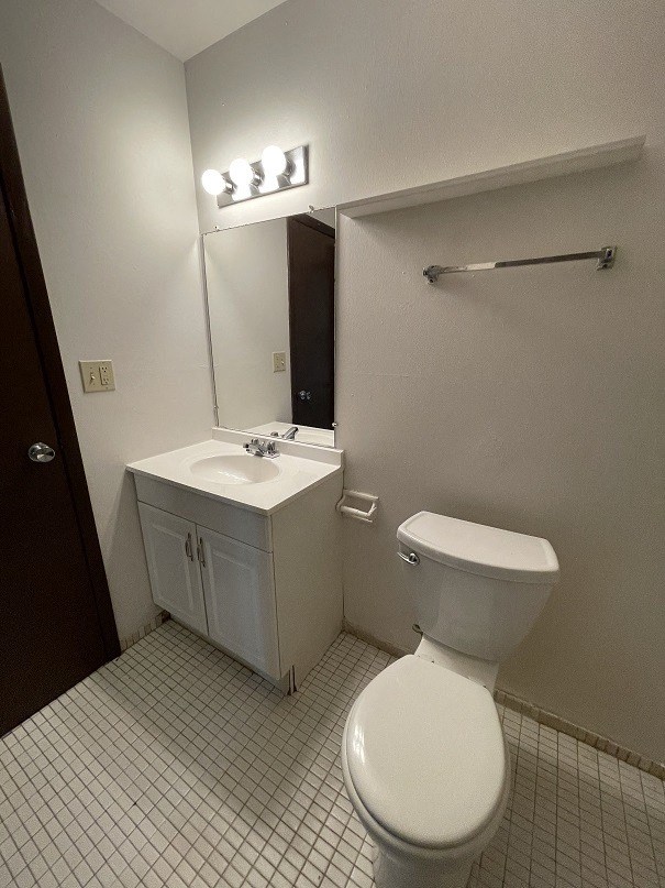 a bathroom with a toilet and a sink and a mirror