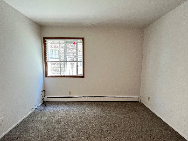 the living room of an empty house with a window