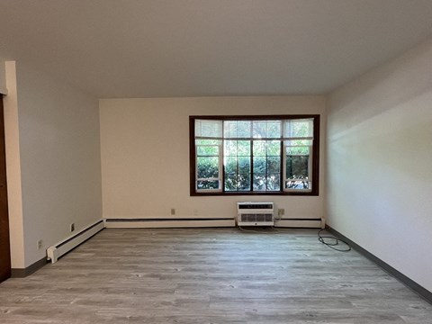 the living room of an empty house with a large window