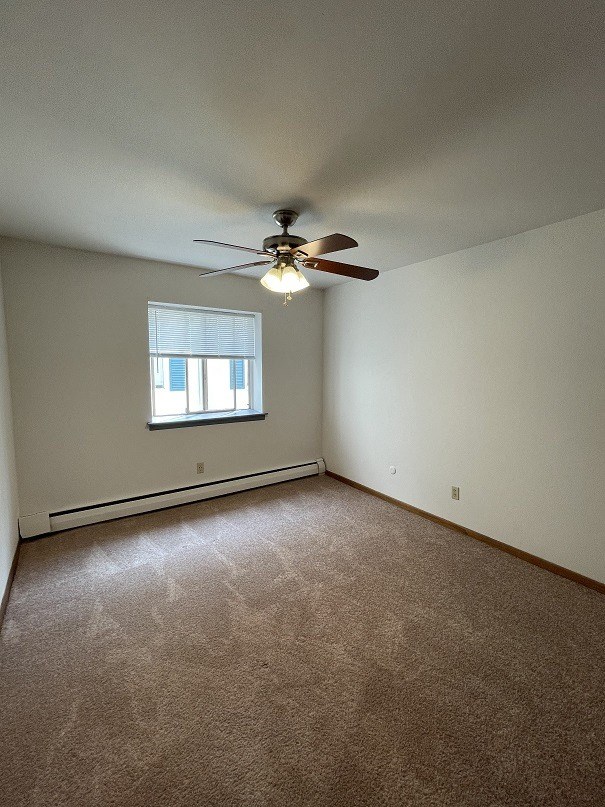 a bedroom with a ceiling fan and a window