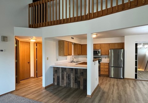 A modern kitchen with wooden cabinets and a central island.