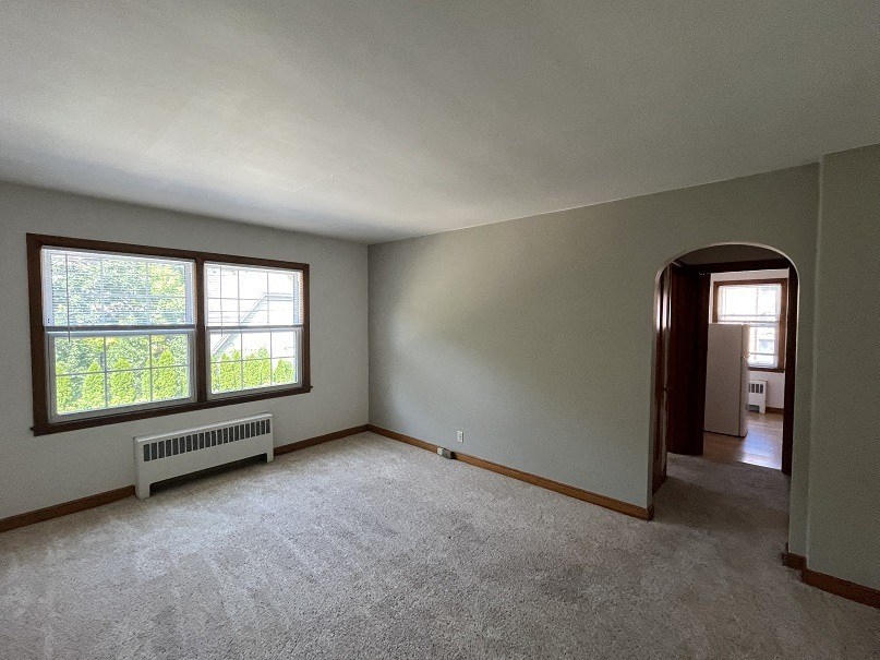 the living room of an empty house with a large window
