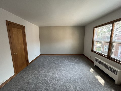 the living room of an empty house with a large window