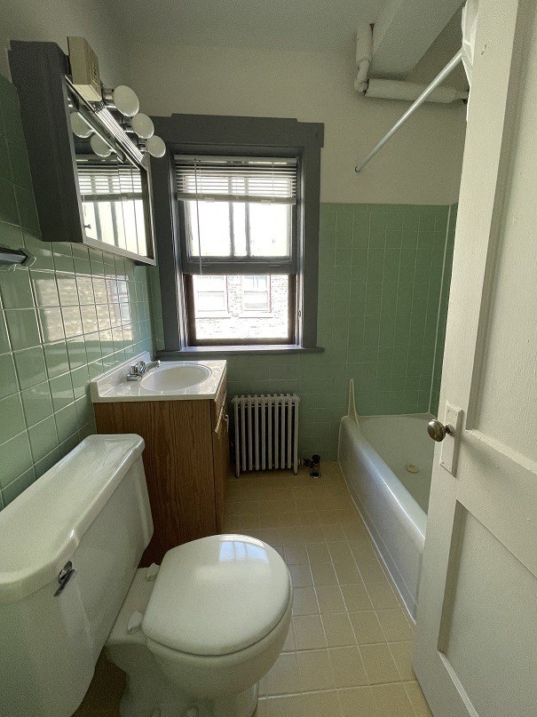 a bathroom with a toilet and a sink and a tub