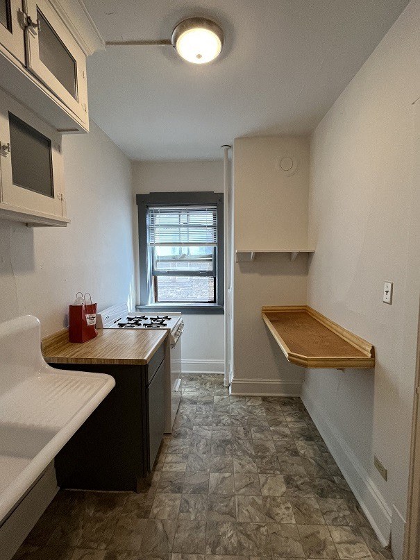 a small kitchen with a stove and a window