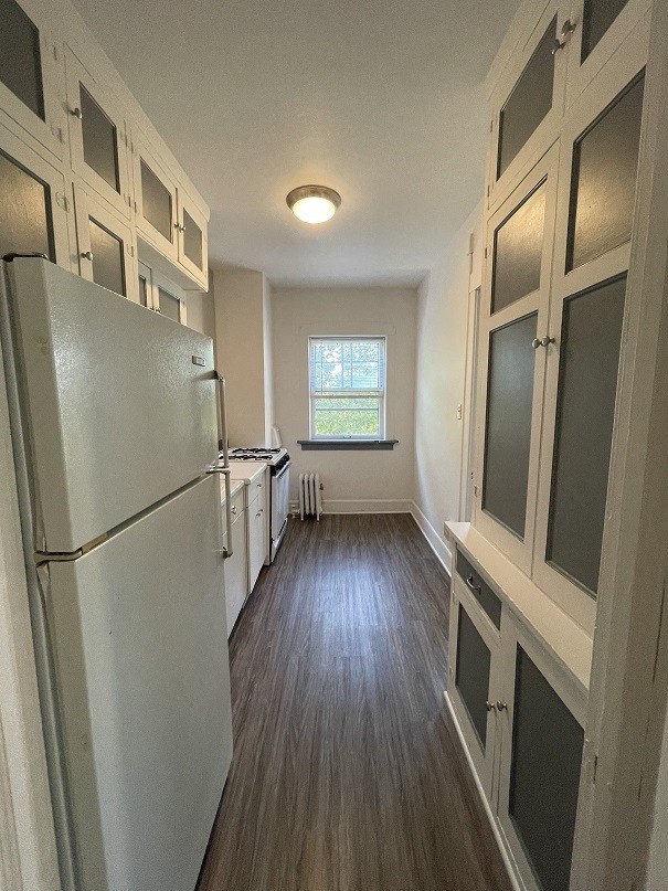 a kitchen with a refrigerator and a window