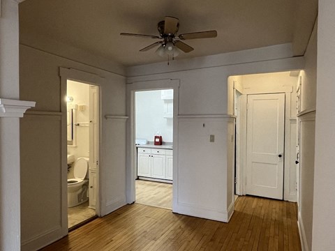 A room with a ceiling fan and a window.