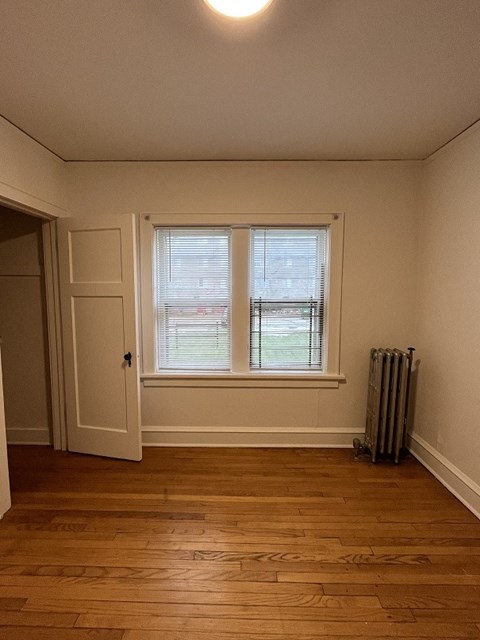 a living room with a window and a radiator