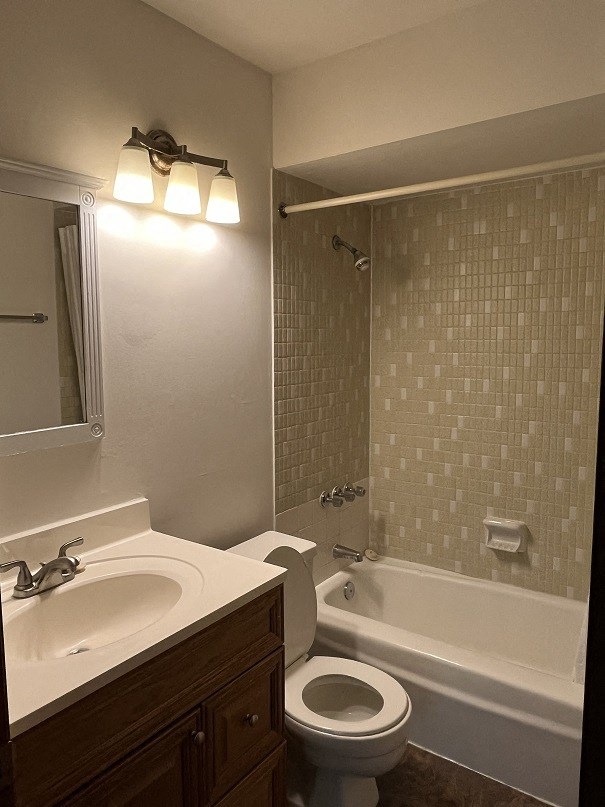 A white toilet sits next to a sink in a bathroom.