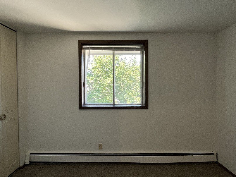 A room with a window and a door.