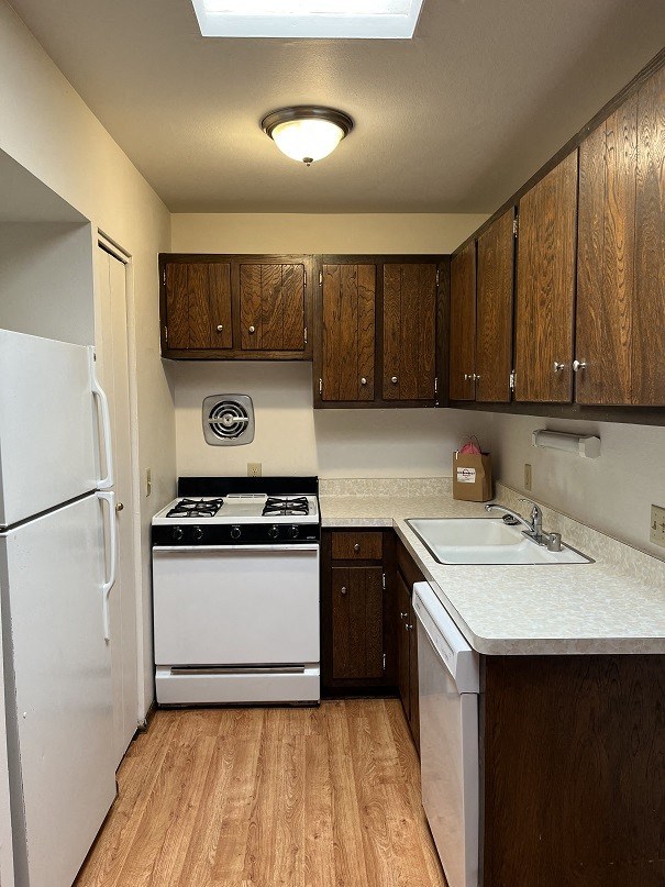 a kitchen with a stove refrigerator and a sink