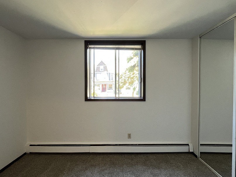 A room with a window and a door.