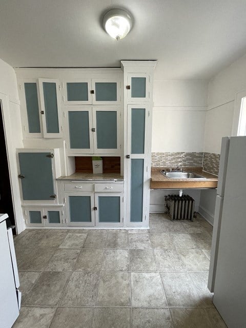 a kitchen with a sink and a refrigerator