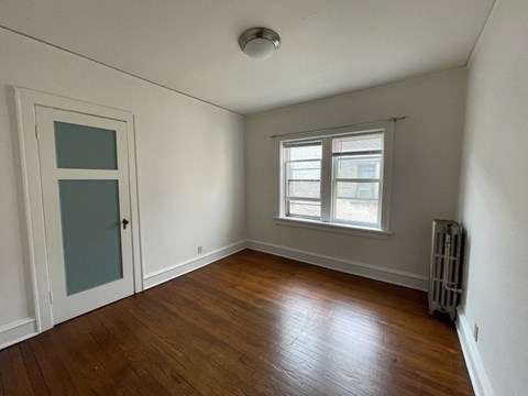 an empty room with a window and a door