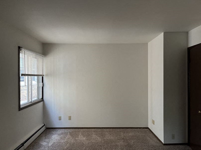 A room with a window and a door.