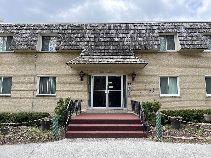 a building with a tile roof and a glass door
