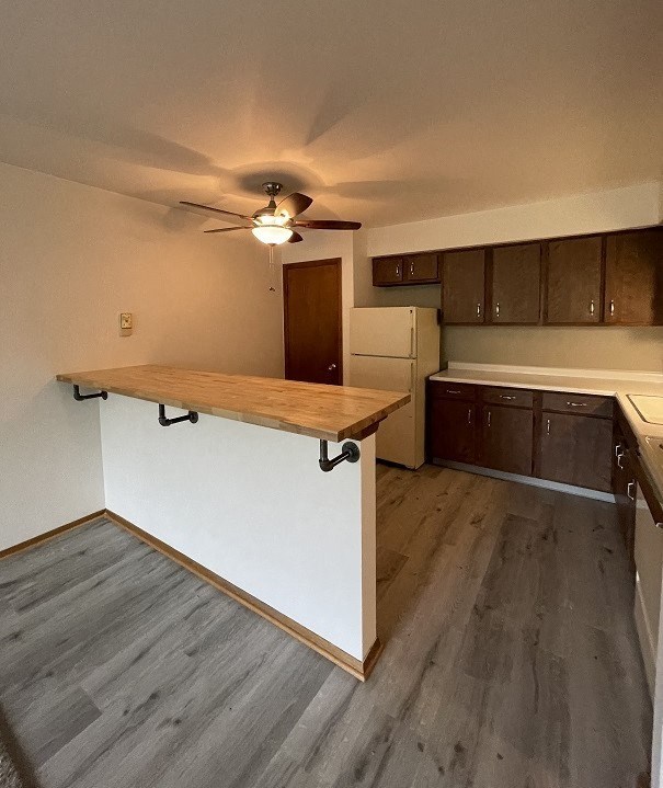 a kitchen with a bar in the middle of it