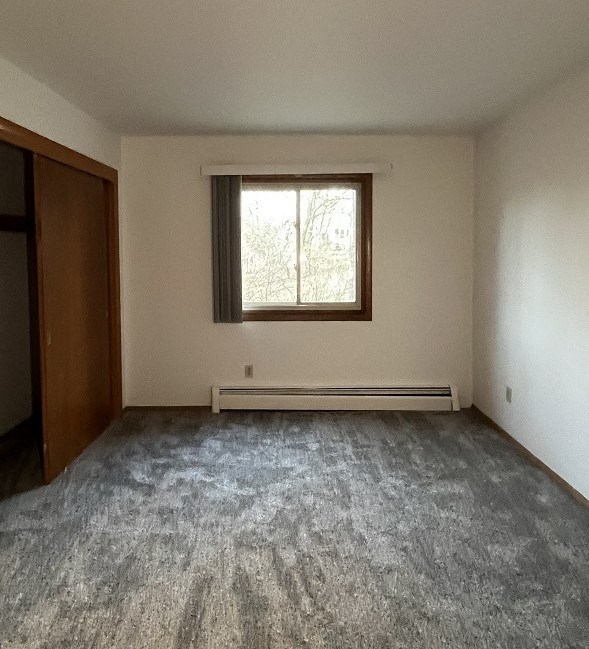 an empty living room with a window in it
