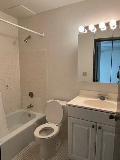 A white bathroom with a toilet, sink, and bathtub.