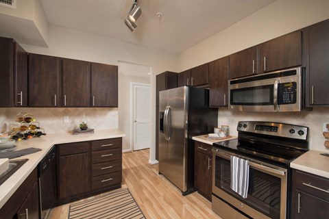 a kitchen with stainless steel appliances and wooden cabinets