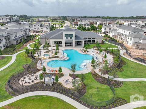 A large building with a pool in front of it.