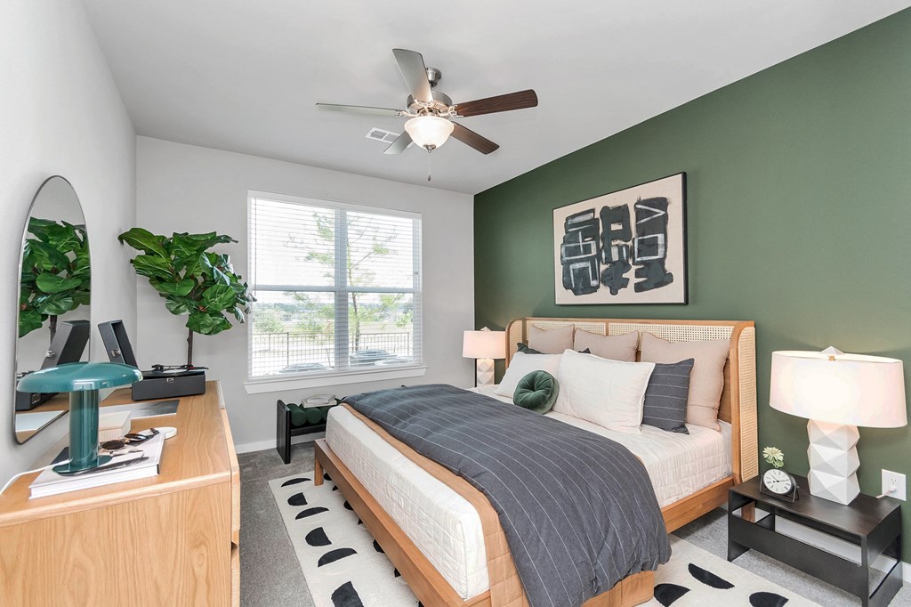 a bedroom with a bed and a ceiling fan