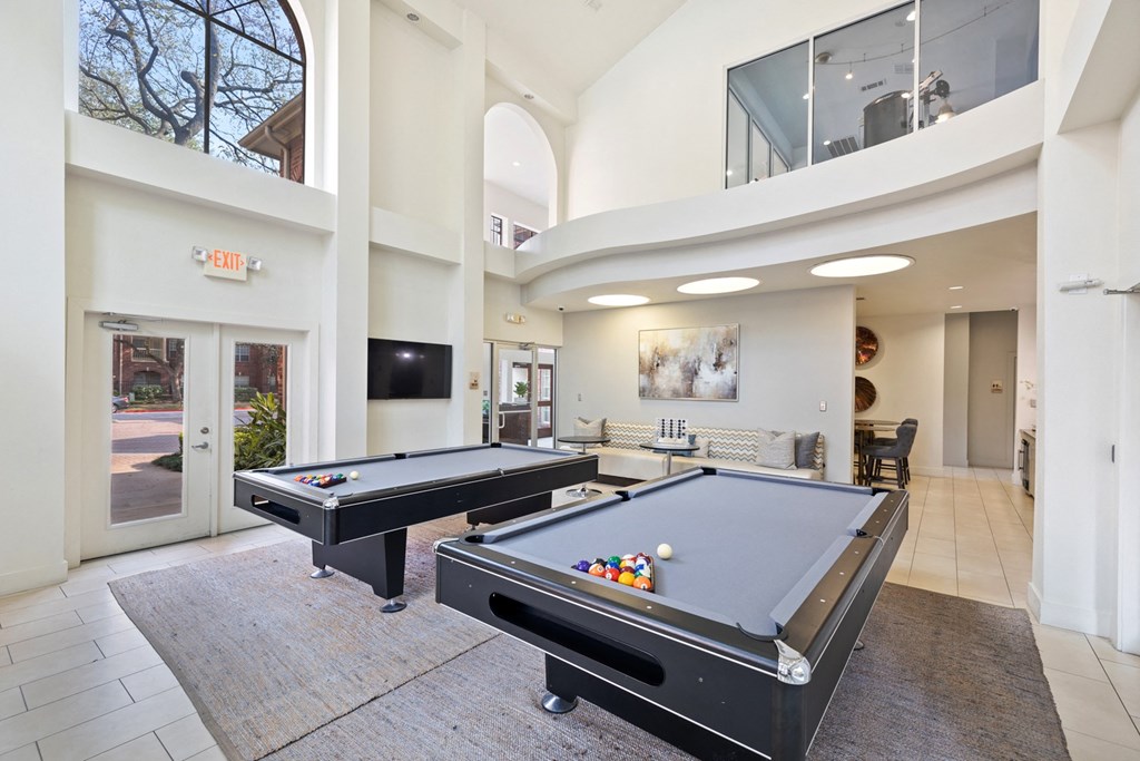 a resident clubhouse with two pool tables and a flat screen tv