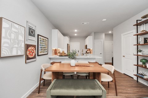 A dining room with a table and chairs.