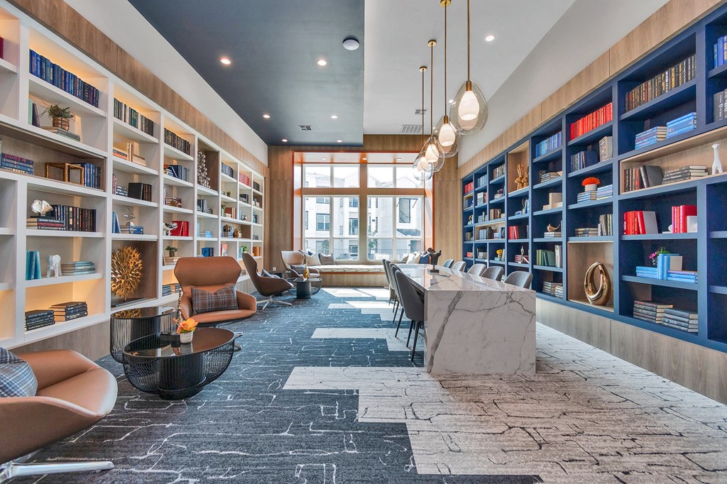 the lobby of a library with a long table and chairs