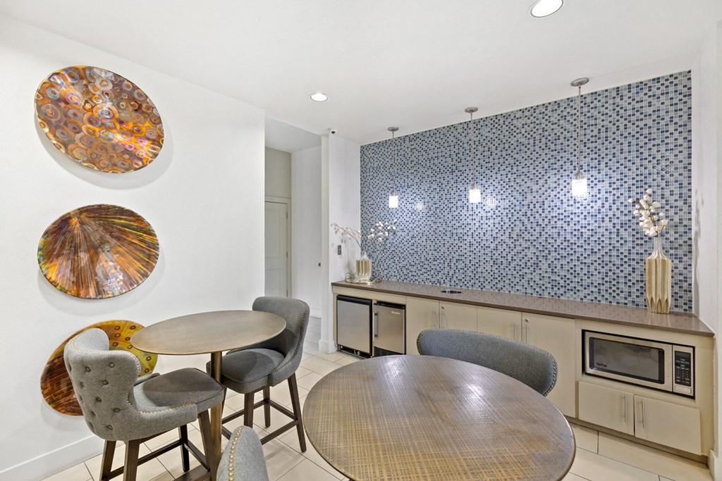 Resident lounge with table and chairs, microwave, dishwasher, and counter