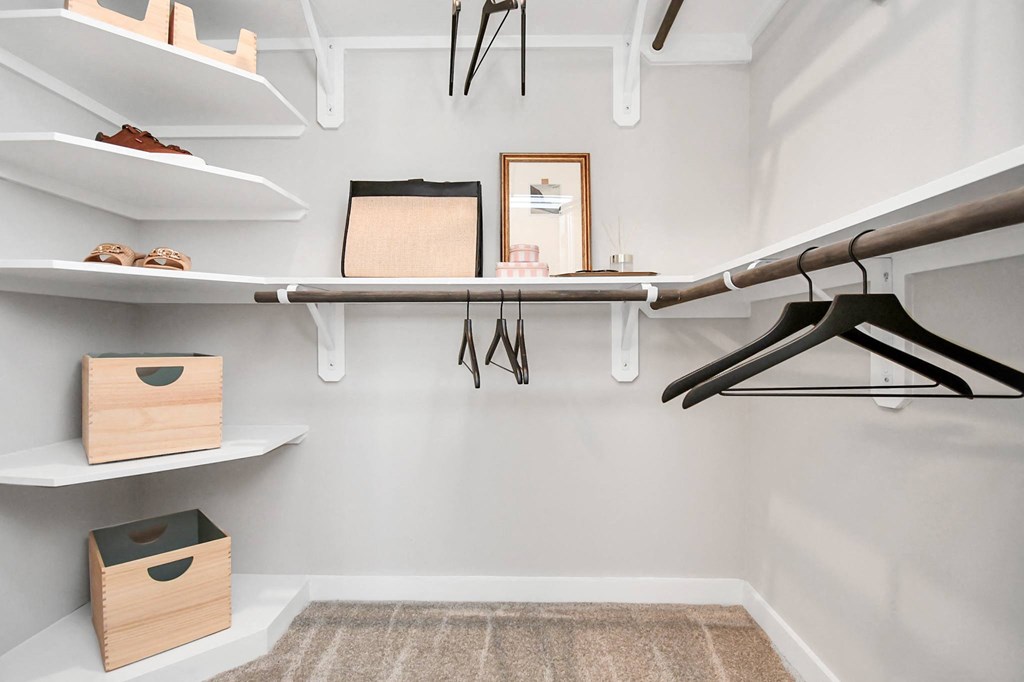 a walk in closet with a surfboard hanging on the wall