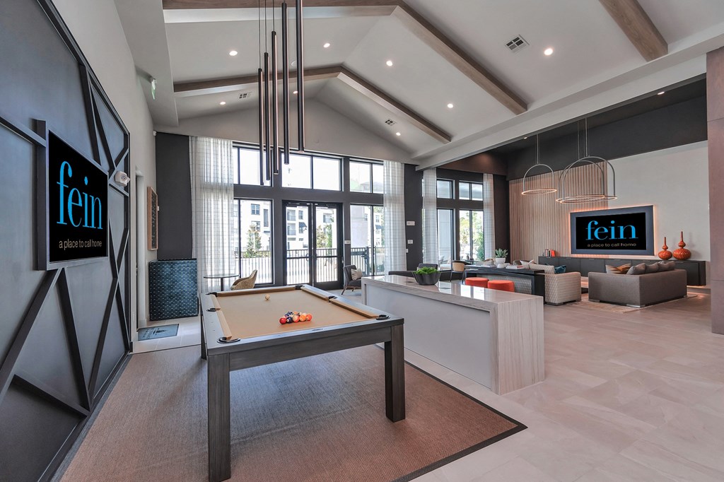 a clubhouse with a pool table in the center of it