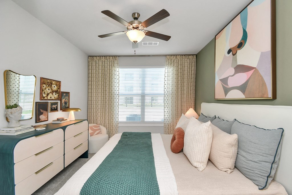 a bedroom with a bed and a ceiling fan