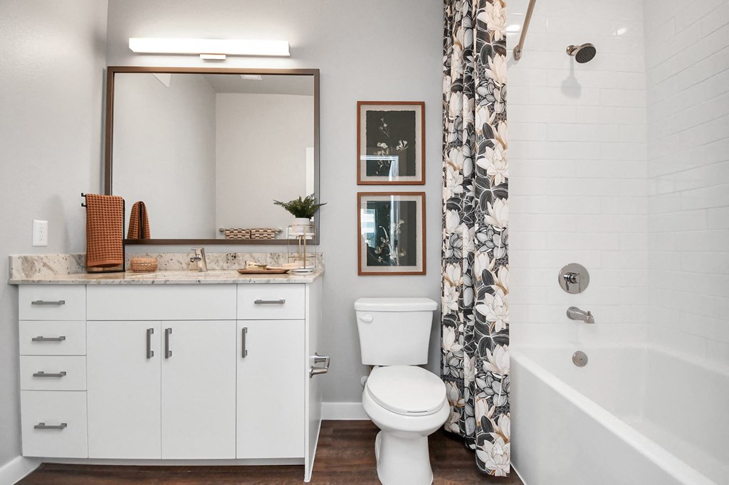 a bathroom with a shower and a toilet and a sink
