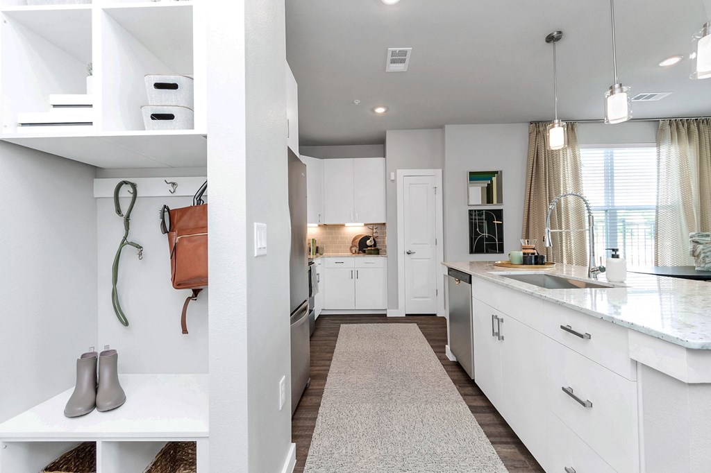 a renovated kitchen with white cabinets and a counter top and a sink
