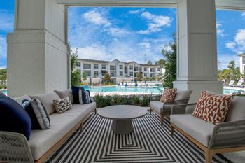 Covered poolside patio with comfortable seating