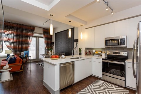 a large kitchen with a sink and a counter top