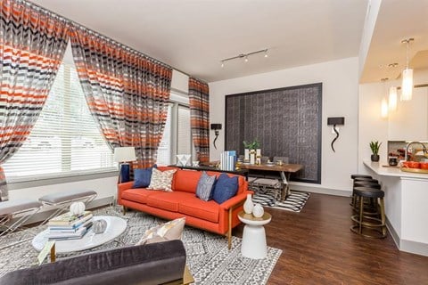 a living room with an orange couch and a table