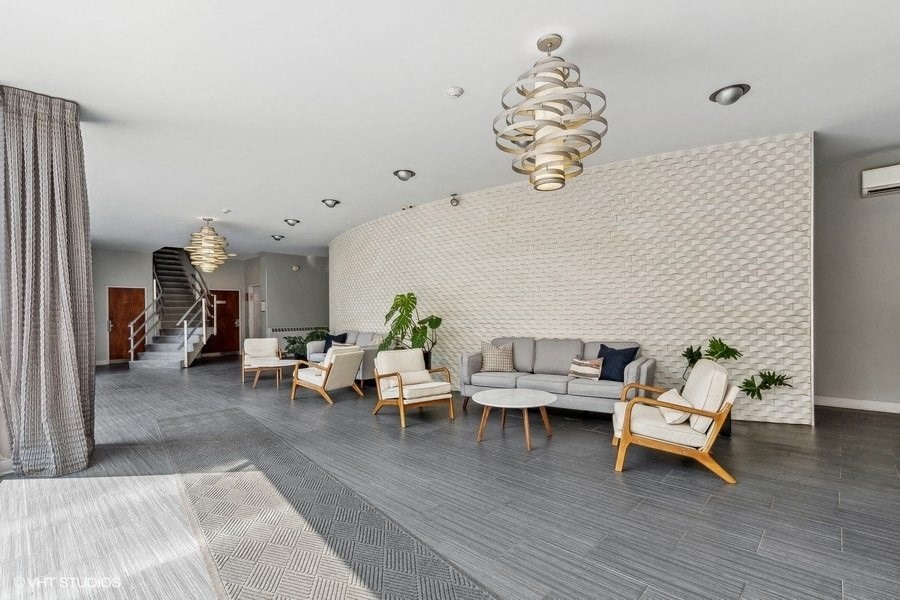 a large lobby with chairs and couches and a spiral staircase