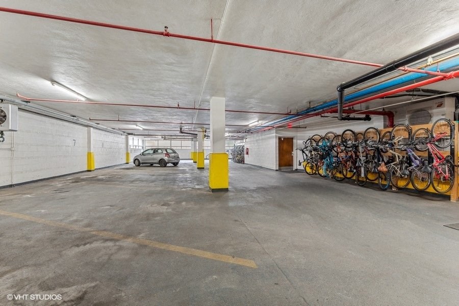 the inside of a parking garage with bikes on the wall