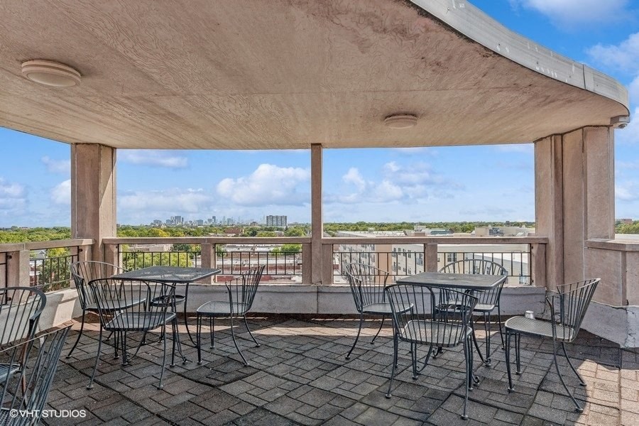 the patio has tables and chairs and a view of the water