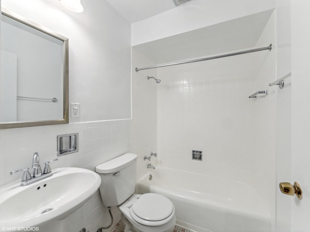 a bathroom with a sink toilet and bathtub