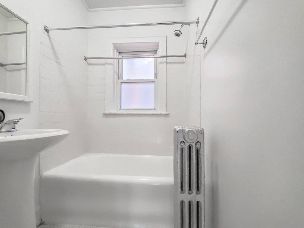 a bathroom with a tub and a sink