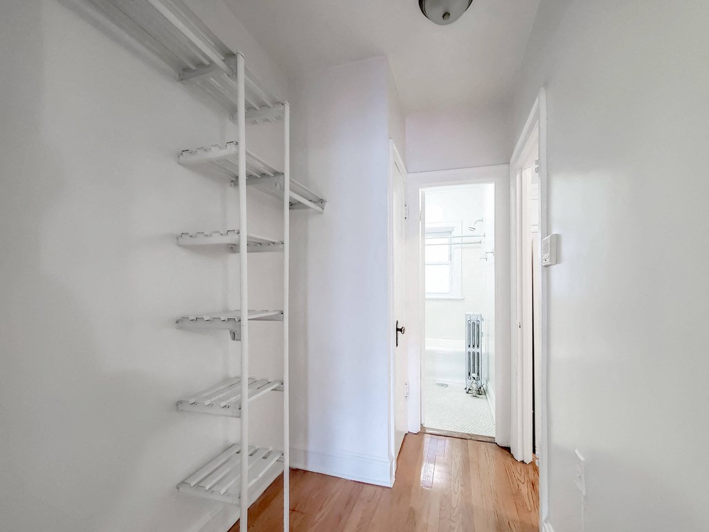 a room with white walls and a white ladder in the corner