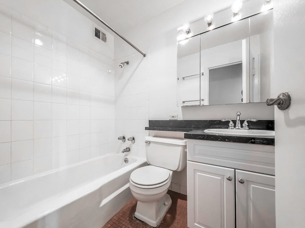 a bathroom with a sink toilet and bathtub