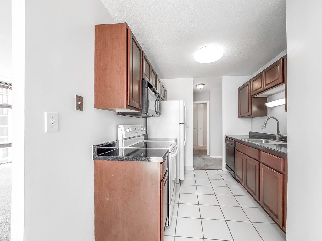 a kitchen with a white refrigerator freezer next to a stove top oven