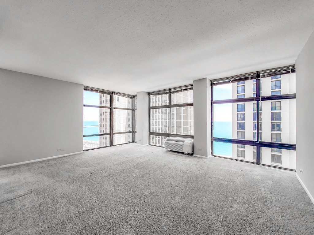 an empty living room with a view of the ocean