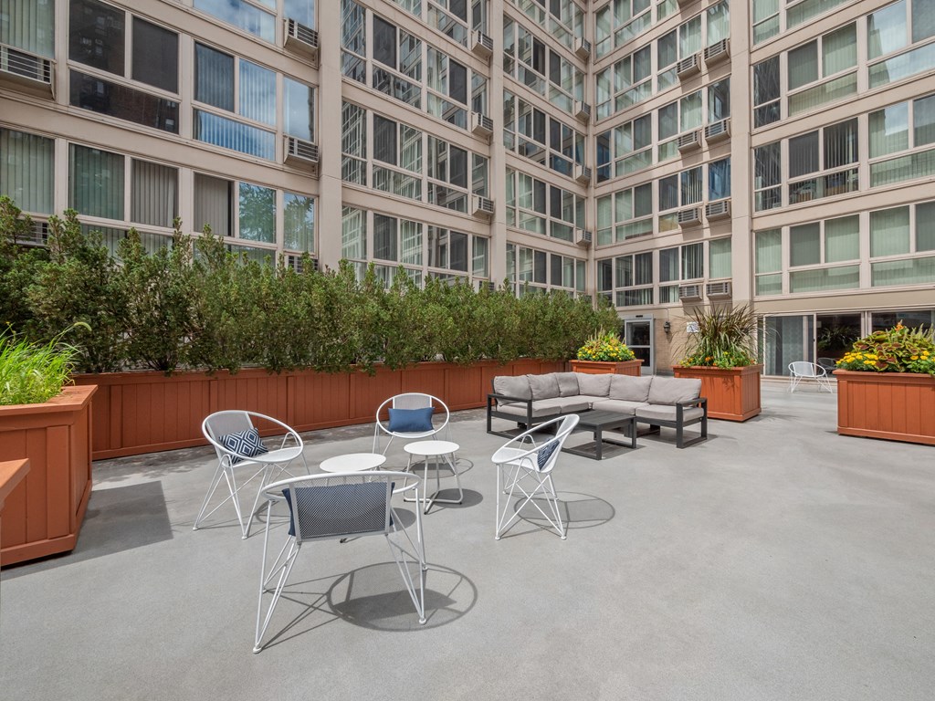 a seating area with a couch and chairs in front of an office building