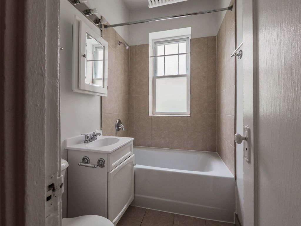 a bathroom with a bathtub and a sink